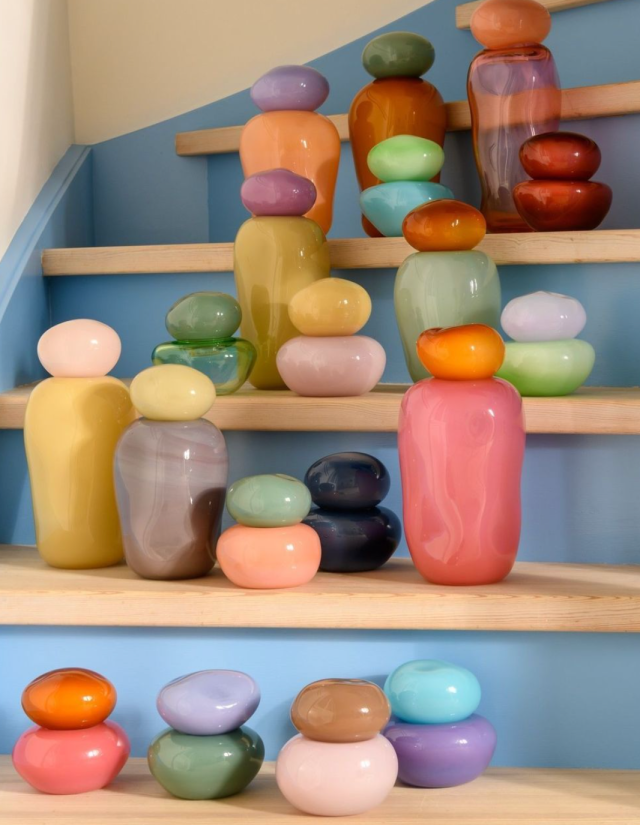 colorful glass rounded decor pieces lined up on baby blue wooden stairs